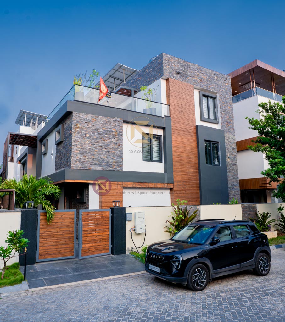 Modern villa facade clad in natural stone and wood with a terrace garden, Hyderabad