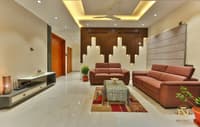 Living room with twin rust leather sofas, backlit wood-slat feature wall and patterned rug on glossy marble floor