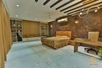 Master bedroom with built-in study desk, full-height storage wall, stone accent panel and slat ceiling detail