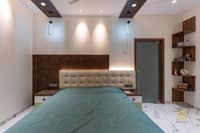 Bedroom with wood-slat headboard wall, tufted beige headboard, teal bedspread and corner display shelves, Hyderabad