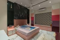 Kids bedroom in blush pink with upholstered bed, black marble headboard wall, floral roman blind and window seat, Hyderabad