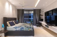 Bedroom with sculpted wave-textured accent wall, upholstered bed, floor-to-ceiling drapes and floating TV unit, Hyderabad