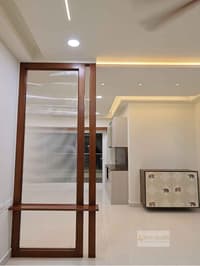 Foyer with a fluted-glass teak partition and bench leading to a kitchen, with elephant-print cabinet, Hyderabad
