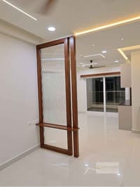 Entryway teak partition in reeded glass with built-in bench, glossy tiled floor and balcony beyond, Hyderabad