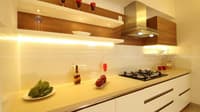 Galley kitchen close-up with glossy white cabinets, walnut floating shelves, gas hob and stainless chimney, Hyderabad