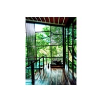 Timber-floored balcony framed by black metal grilles and floor-to-ceiling glass open to lush forest views, Hyderabad
