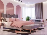 Blush bedroom with arched padded niches, grey velvet headboard, pink duvet, chaise and rose-gold lamps, Hyderabad