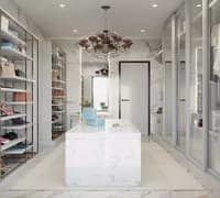 White marble walk-in closet with glass shelving, mirrored island, crystal chandelier and shoe display, Hyderabad