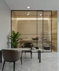 Glass-partitioned dressing or spa room with timber slat walls, marble floor and ribbed accent chairs, Hyderabad