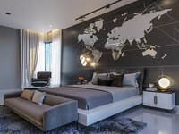 Master bedroom with backlit world-map marble feature wall, grey platform bed, globe lamp and accent chair, Hyderabad