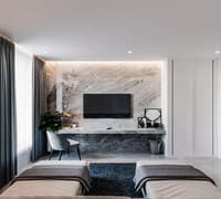Bedroom lounge with grey marble TV wall, floating console, accent chair and twin upholstered daybeds, Hyderabad