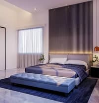 Bedroom with vertical fluted accent wall, backlit headboard, low blue tufted bench and navy rug, Hyderabad