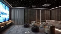 Home theatre room with star-lit ceiling, large screen, beige modular sofas and bean bags on patterned carpet, Hyderabad