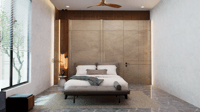 Minimalist bedroom, low platform bed on a woven rug over grey marble, beige stone wall and ceiling fan, Hyderabad