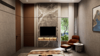Bedroom TV unit clad in brown marble with backlit niche, wood wardrobes and a tan leather recliner by greenery, Hyderabad