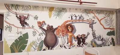 Hand-painted kids bedroom wall mural in Hyderabad with cartoon jungle animals — lion, hippo, giraffe, monkeys and zebra