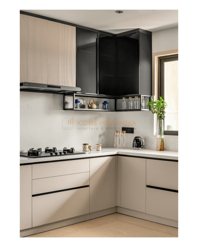 L-shaped kitchen with cream fluted and glossy black cabinets, stainless chimney and white quartz countertop, Hyderabad