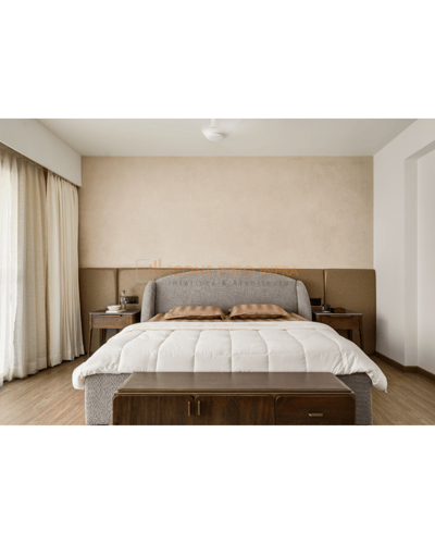 Master bedroom in warm neutrals, upholstered headboard, twin nightstands and a wooden bench at the foot of the bed