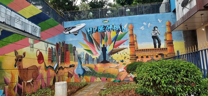 Public street mural with Hyderabad skyline, Charminar, peacock and wildlife motifs, GHMC project