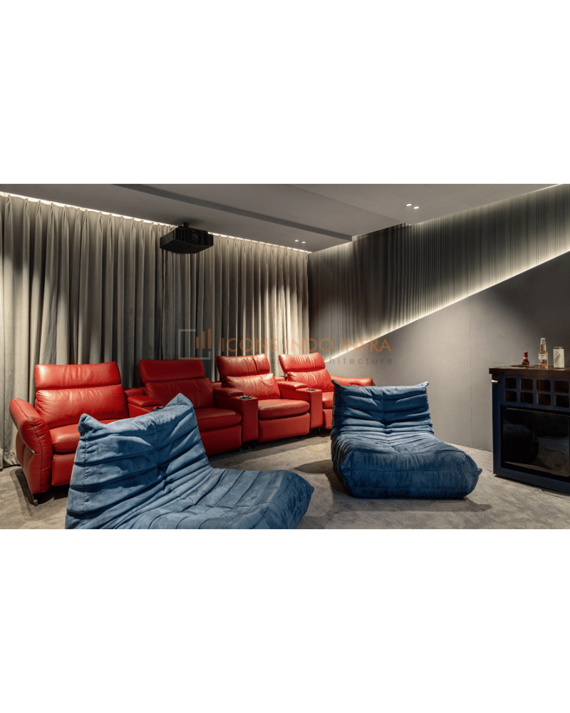 Home theatre rear view with red recliners, blue floor loungers, grey drapes and ceiling projector under cove lighting