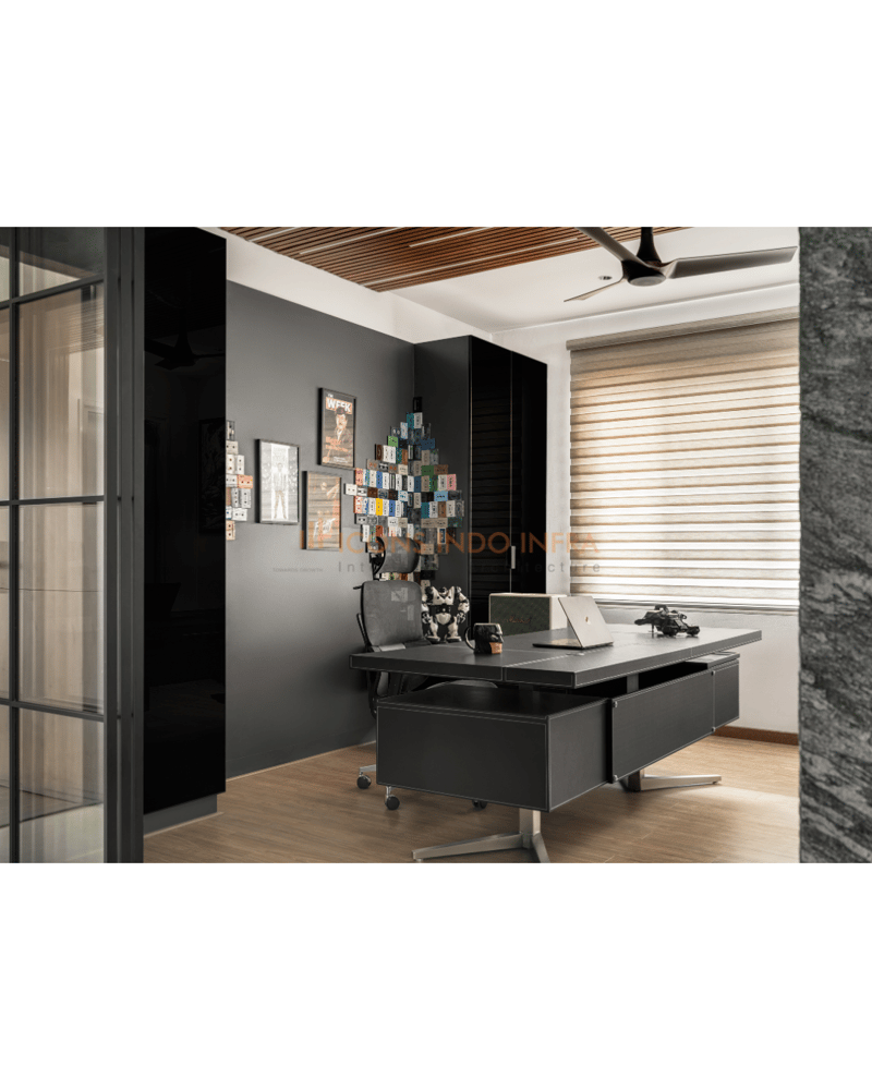 Home study with dark grey desk, glossy black wardrobe, slatted-wood ceiling and glass partition framing a corner workspace