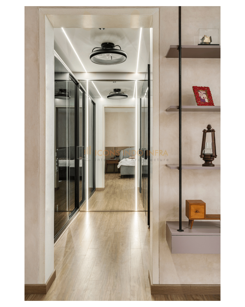 Lit passage lined with mirrored sliding wardrobes and open display shelves, opening into the bedroom beyond