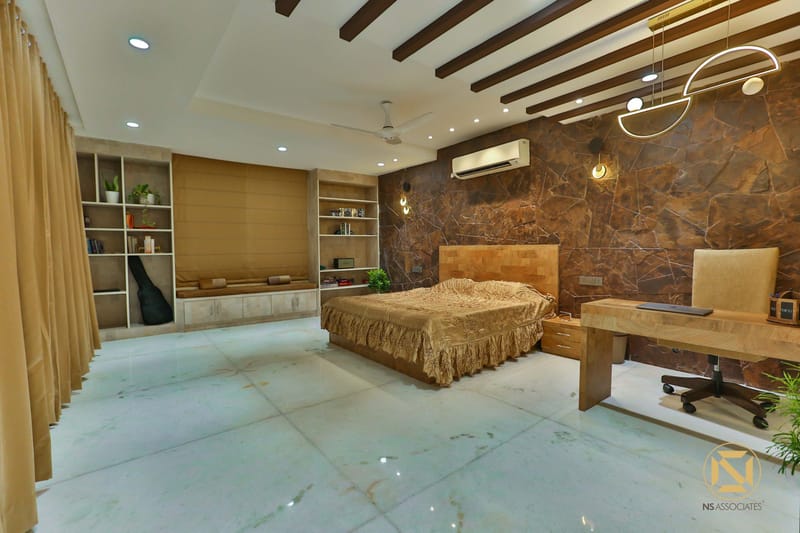 Master bedroom with built-in study desk, full-height storage wall, stone accent panel and slat ceiling detail