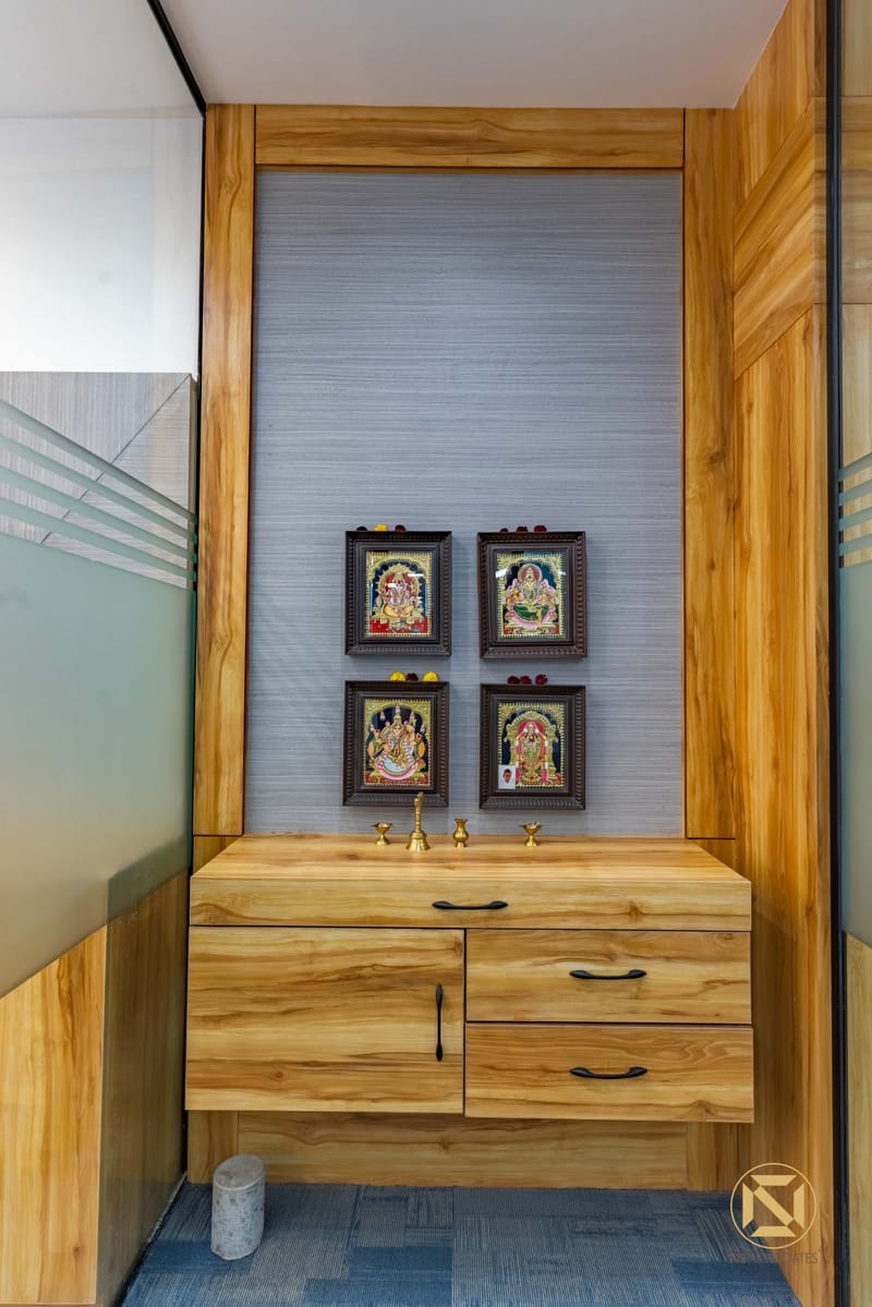 Wood-clad puja unit with floating cabinet, textured grey panel and four framed Tanjore deity paintings, Hyderabad