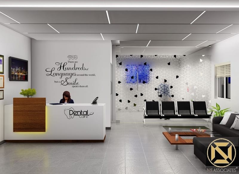 Dental clinic reception in Hyderabad with white desk, wood accent, black waiting chairs and geometric blue-lit feature wall