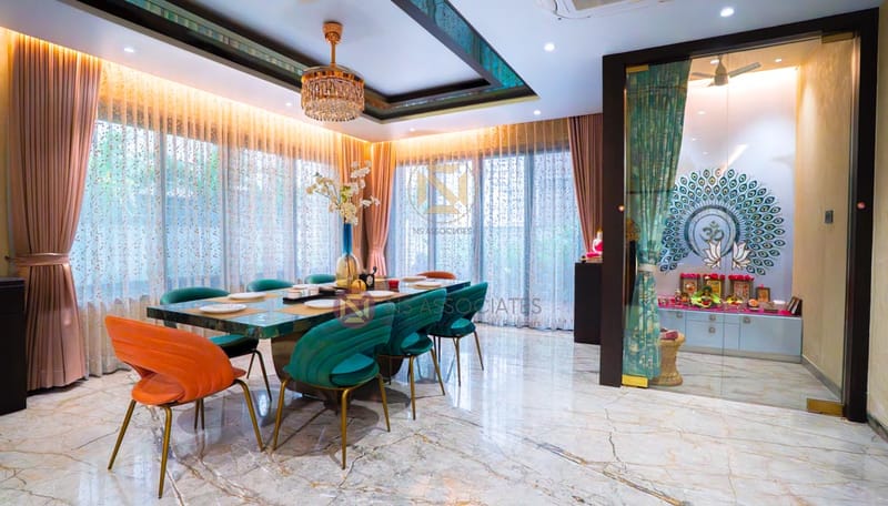 Dining room with marble floor, green velvet and orange chairs, crystal chandelier and pooja unit, Hyderabad