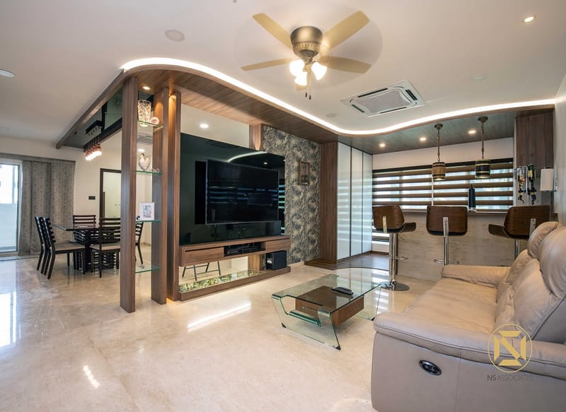 Open-plan living room, Hyderabad: beige leather recliner sofa, glass coffee table, wood TV unit, dining set and bar-stool kitchen counter