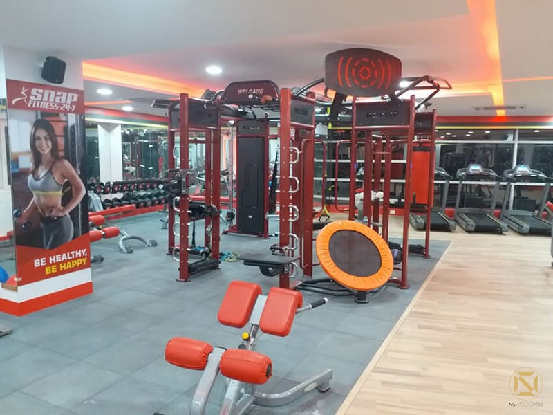 Gym functional-training rig with rebounder trampoline, red weight benches and motivational wall graphic, Hyderabad