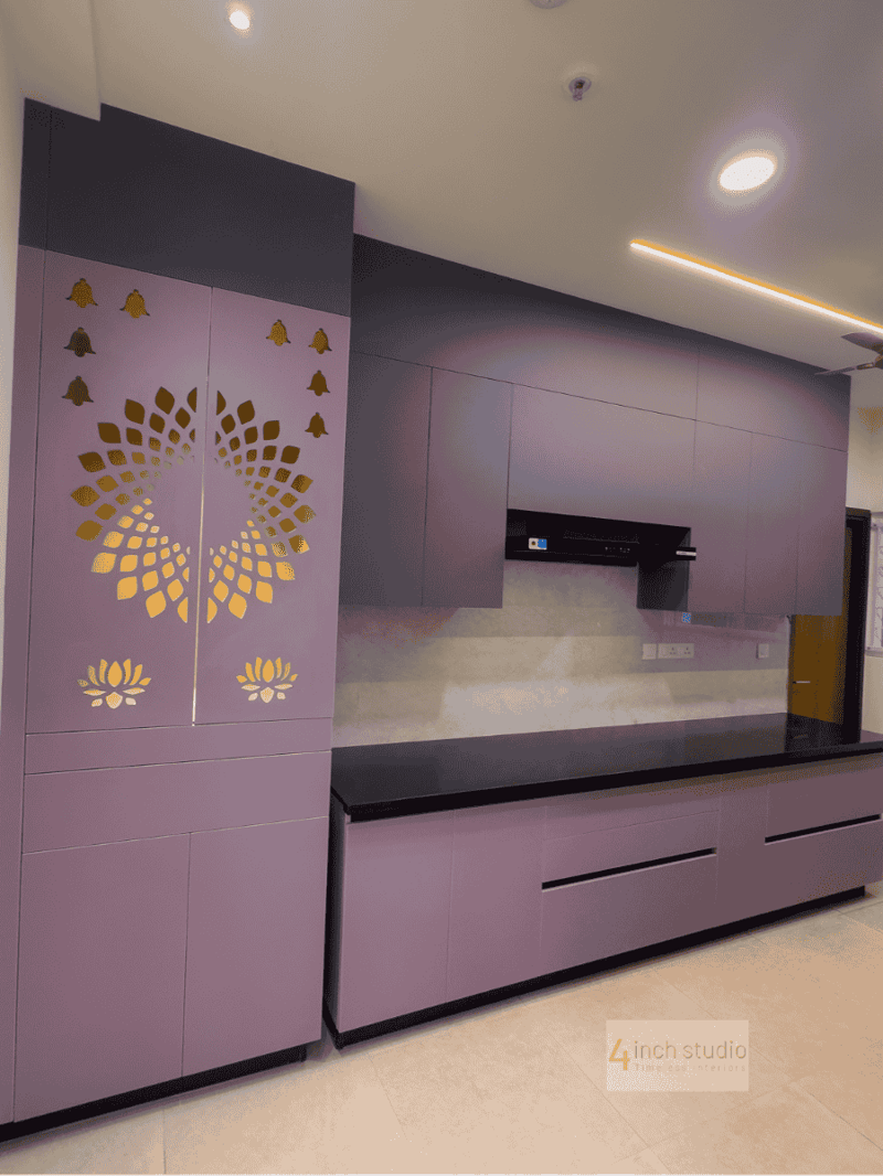 Mauve modular kitchen with gold lotus jali pooja unit, black granite counter and glossy cabinets, Hyderabad