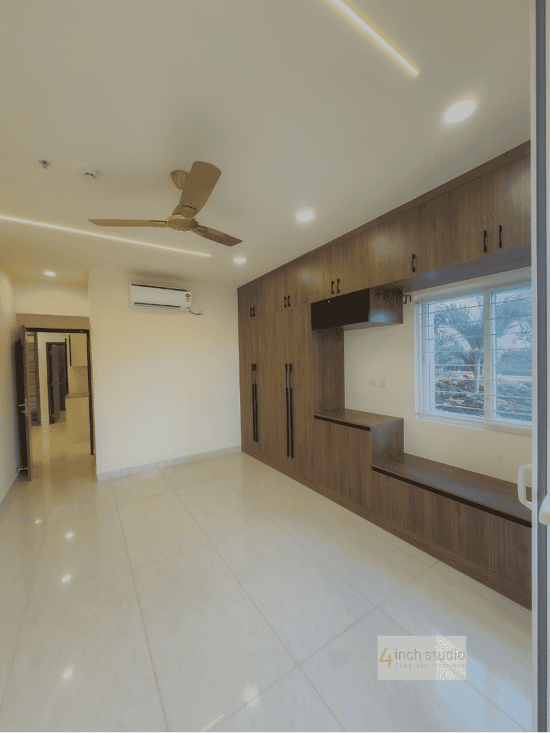 Bedroom with grained-wood wardrobe, wall-mounted TV unit, split AC and large window over glossy tile, Hyderabad