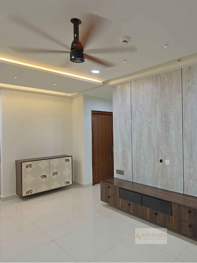 Living and dining area with cove-lit false ceiling, wood ceiling fan and an elephant-motif sideboard, Hyderabad