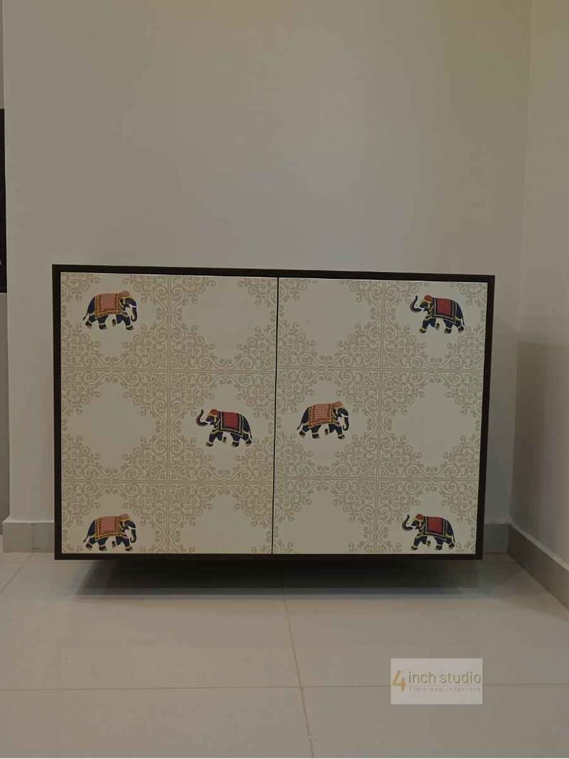 Cabinet doors in white with gold damask print and colourful caparisoned elephant decals, Hyderabad home
