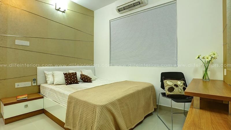Bedroom in Hyderabad with horizontal wood-panel headboard wall, beige bedspread, study corner and roller blind