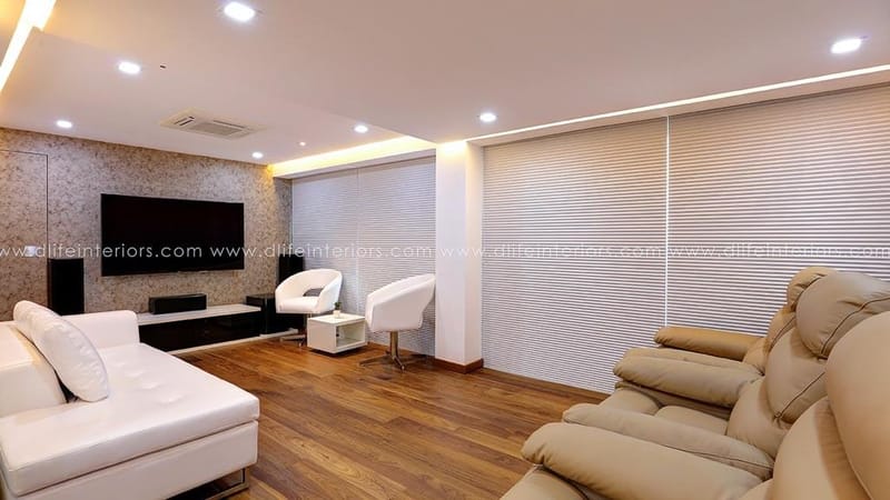 Black-and-white bedroom in Hyderabad with platform bed, red lounge chair, mirrored wardrobe and pendant lights