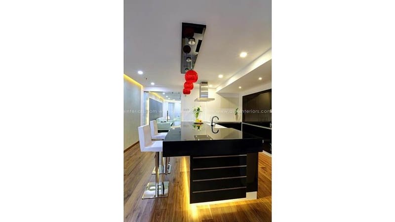 Modern open kitchen with glossy black island, white bar stools, red pendant globes and warm under-cabinet LED, Hyderabad