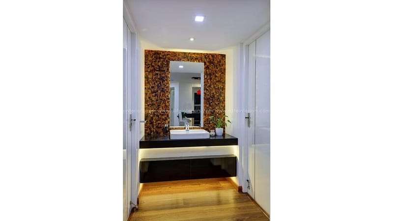 Bedroom with black upholstered headboard wall, red egg chair and striped rug, monochrome bedding, Hyderabad home