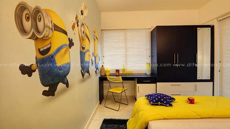Kids bedroom with Minions wall mural, navy-and-white wardrobe, yellow study chair and bright bedding, Hyderabad