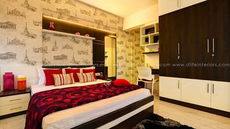 Bedroom with monochrome landmark-print wallpaper, red patterned bedding and a two-tone sliding wardrobe, Hyderabad