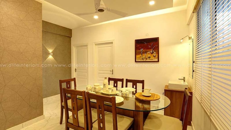 Compact dining room with round glass-top table, wooden chairs and a framed deer artwork, Hyderabad