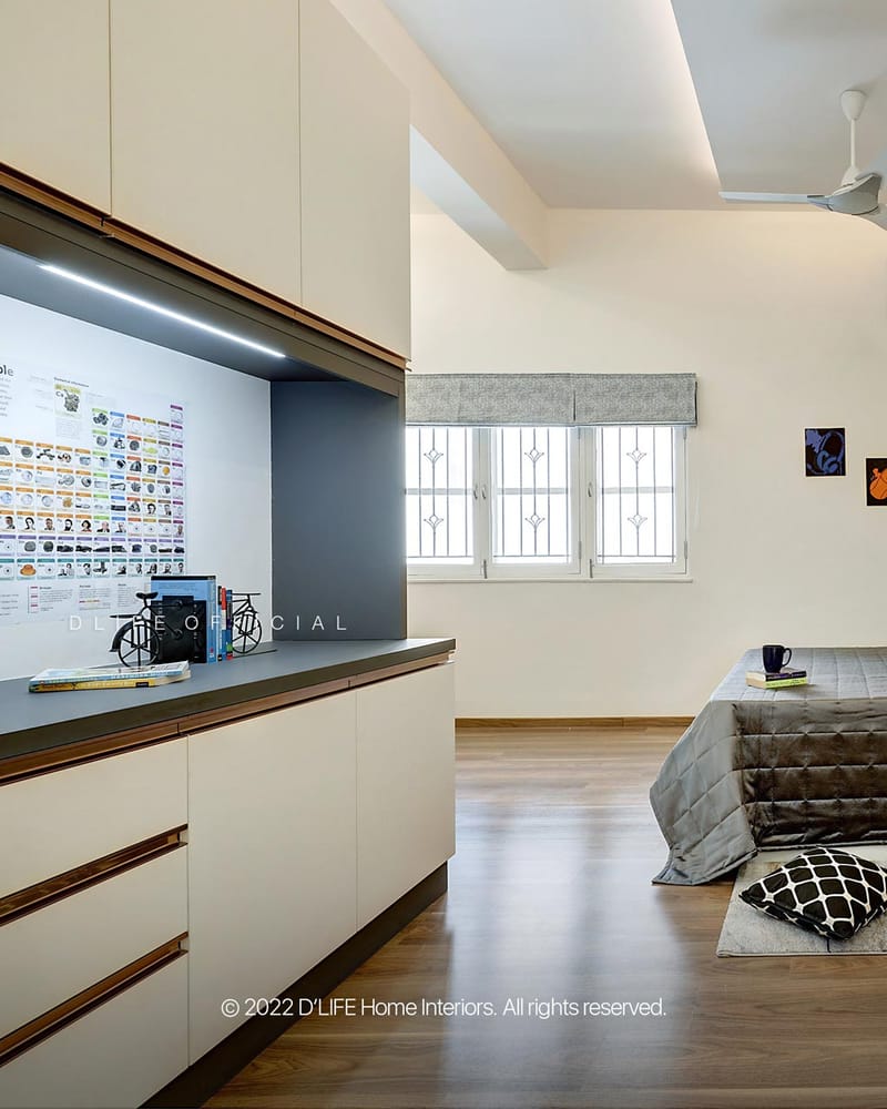 Bedroom study corner with built-in white desk, slim drawers and louvered windows under a Roman blind, Hyderabad