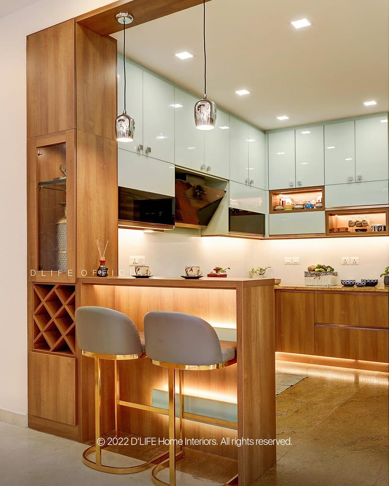 Modern kitchen with breakfast bar, grey upholstered bar stools, glossy mint cabinets and warm under-cabinet lighting, Hyderabad