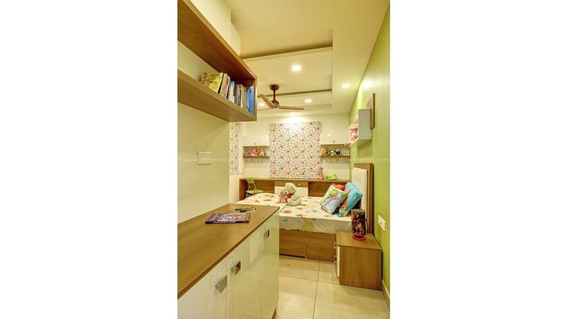 Children's bedroom with lime-green wall, single bed, open wooden study shelves and floral roman blind, Hyderabad