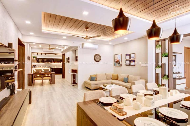 Open-plan living and dining with wood-slat ceiling, beige L-sofa and black pendant lights, full home interior in Hyderabad