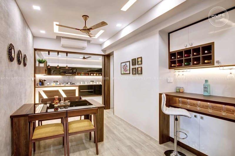 Compact dining nook beside a wooden breakfast bar with bar stool and recessed kitchen, full home interior, Hyderabad