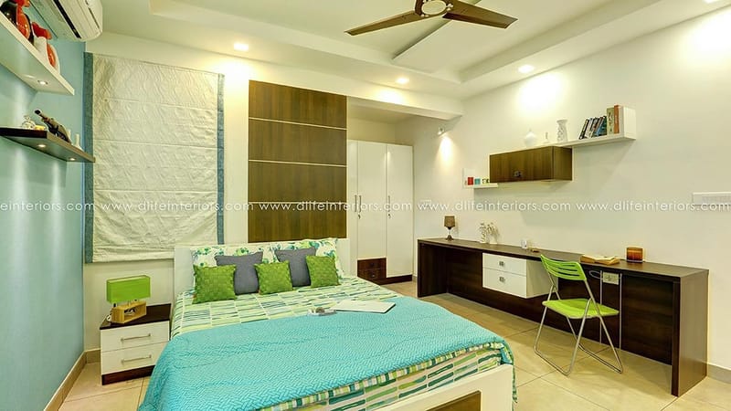 Kids bedroom with teal accent wall, green-blue bedding, built-in study desk and wardrobe, Hyderabad