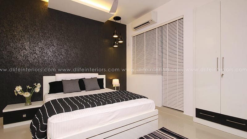 Bedroom with black textured accent wall, striped bedding, white sliding-door wardrobe and blinds, Hyderabad